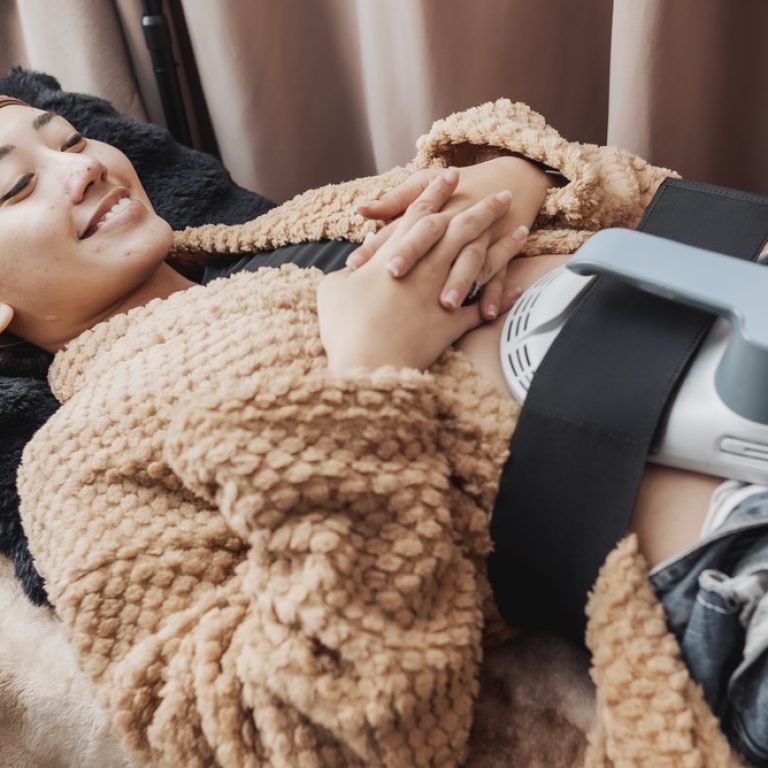 woman using Emsculpt on her midsection in Arlington VA